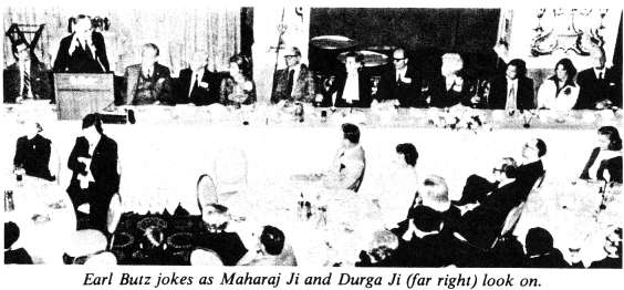 Earl Butz jokes as Maharaj Ji and Durga Ji (far right) look on
