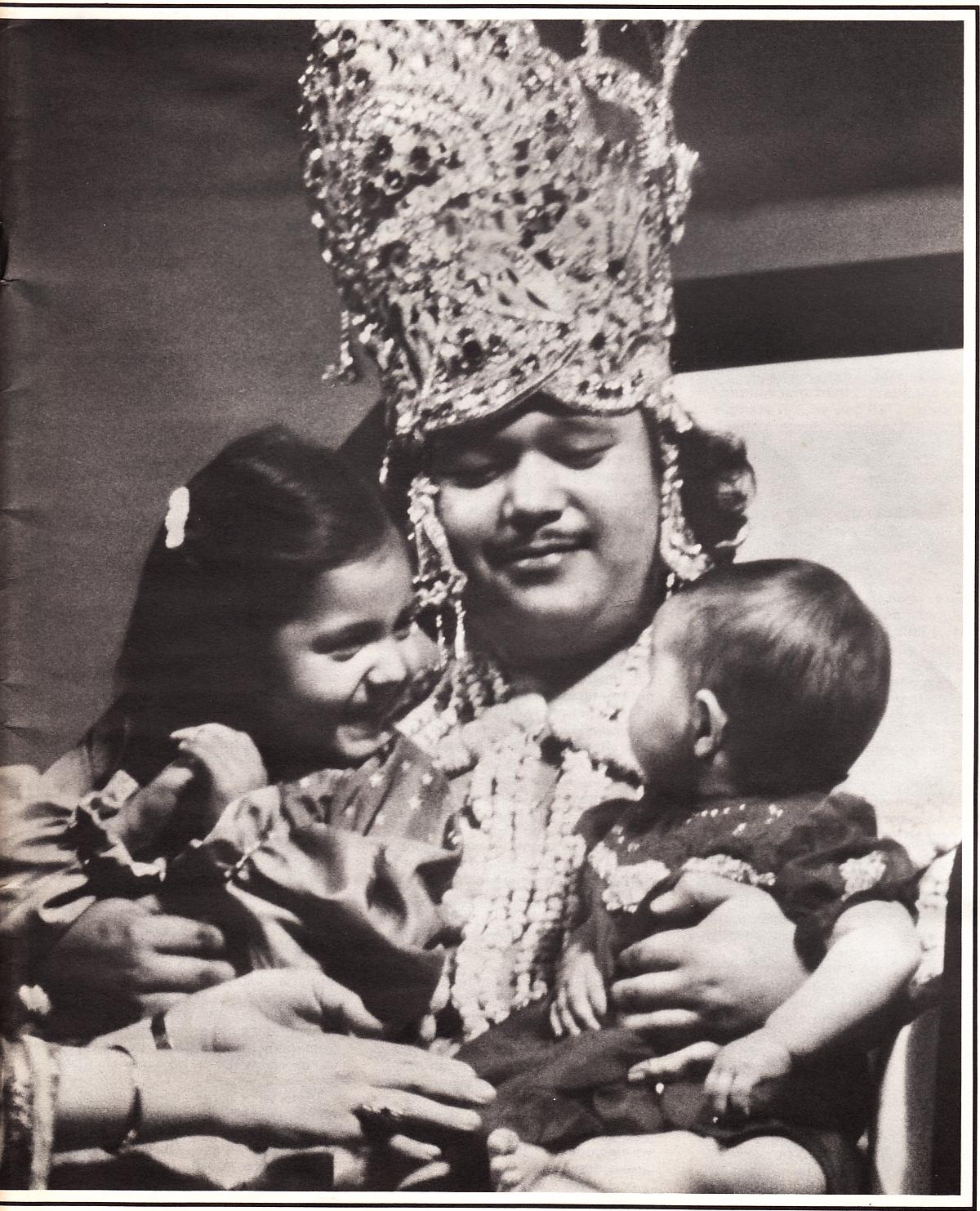Prem Rawat (Guru Maharaj Ji) on a Large Vulgar Throne On Stage Dressed as the God Krishna and Holding His Children